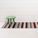 Shuffle Stripe Shag Mat displayed in a stylish entryway, combining both elegance and durability.