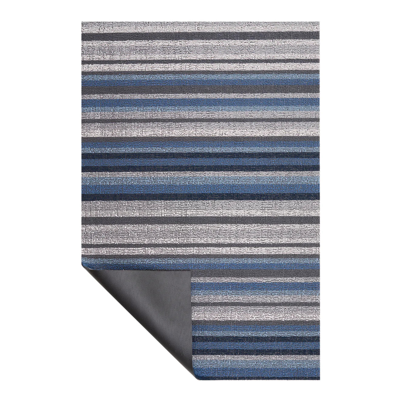 Close-up view of the Horizon Stripe Shag Mat by Chilewich, showcasing its looped TerraStrand yarns in Deep Sea color, designed to resist mold, mildew, and chlorine.