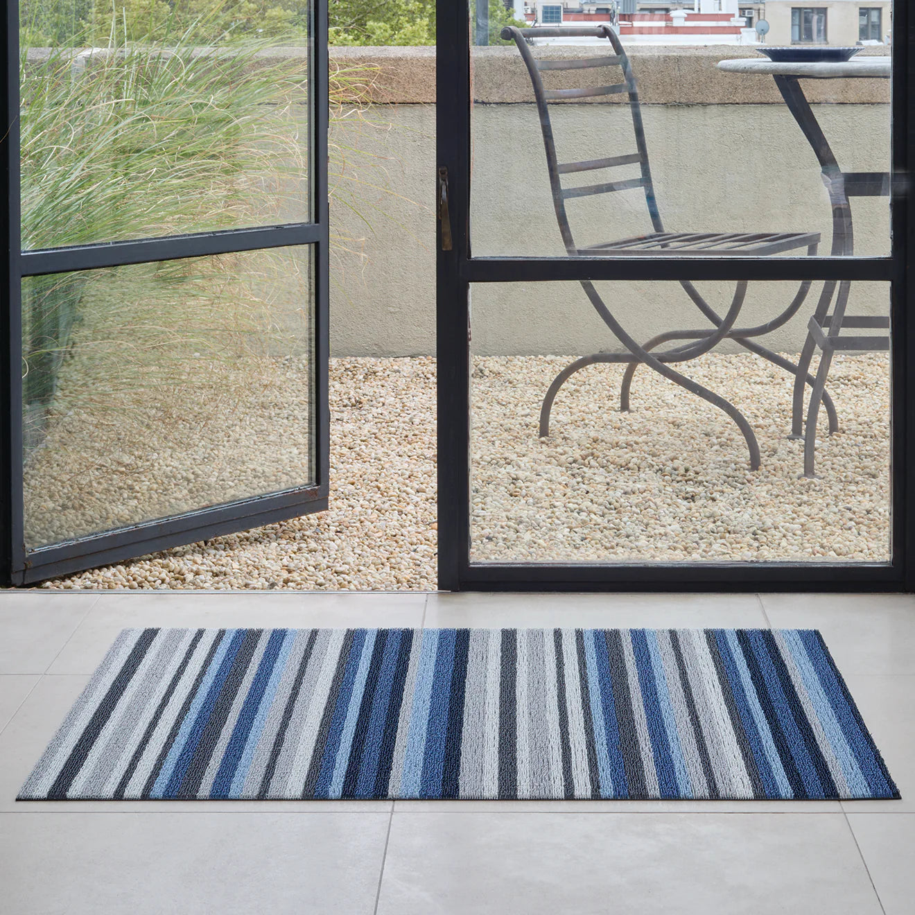 Horizon Stripe Shag Mat in Deep Sea color by Chilewich, featuring dynamic color stripes inspired by landscapes and seascapes, perfect for indoor and outdoor use.