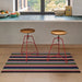 Shuffle Stripe Shag Mat in vibrant colors by Chilewich, showcasing a dynamic striped design perfect for indoor and outdoor use.