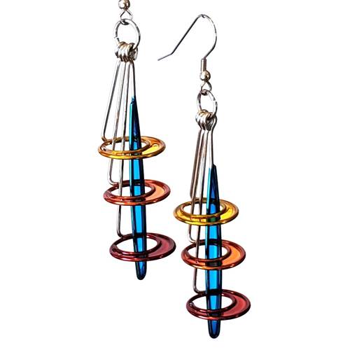 Triple Stacked Orbit Slice Earrings designed by Christopher Royal, featuring a unique combination of stainless steel and translucent resin, showcasing a blend of urban sophistication and playful elegance.