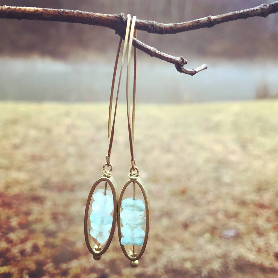 Icy Blue Brass Dangle by Suzanna Garrett Designs — icy blue glass gets a warm brass frame in these elegant drop earrings
