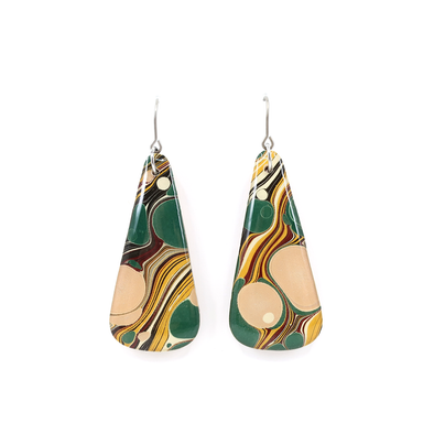 A display of unique green, yellow, pink beige mid-century modern long earrings showcasing their laser cut wood and titanium wire hooks.