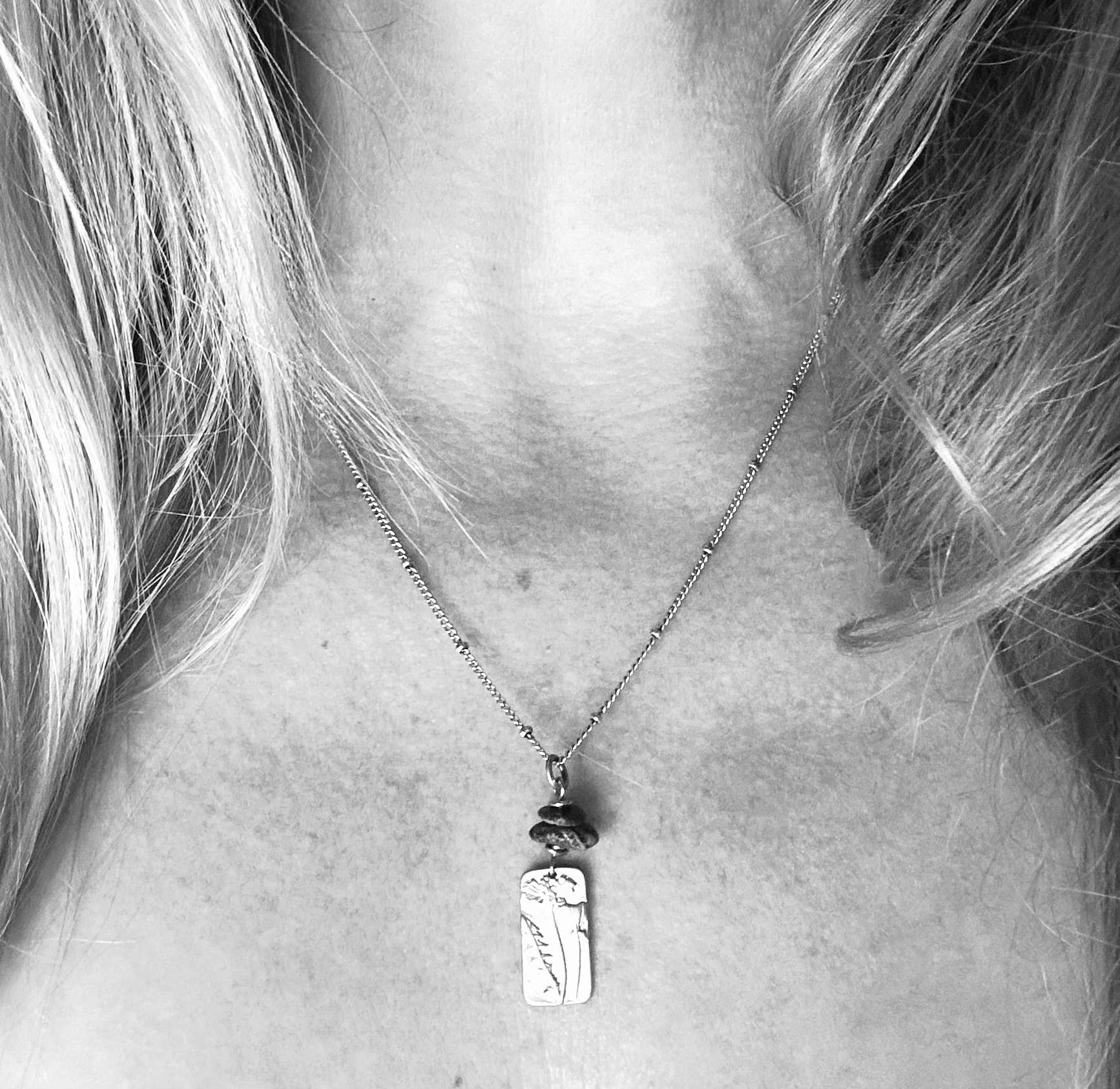 Alternate view of Flower Power Necklace by Suzanna Garrett Designs — a dainty wildflower pendant gets a little extra texture from dark river stone pebbles