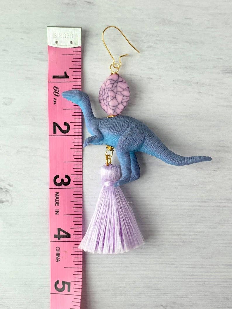 dinosaur earring with purple tassel