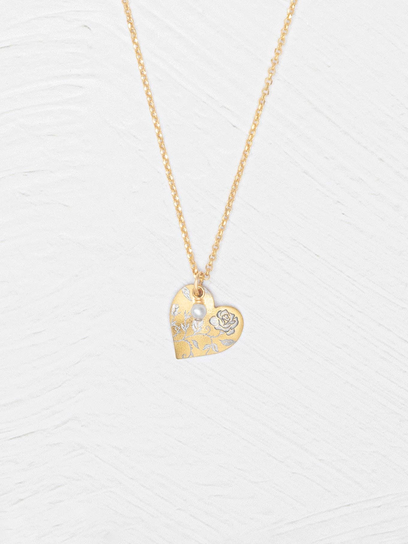 Budding Heart Pendant: a cheeky little gold pendant with a sweet etched bloom and a pearl, perfect for whispering romance without the drama.