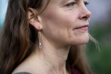 woman wearing Skinny rectangle bar earrings with silver cluster