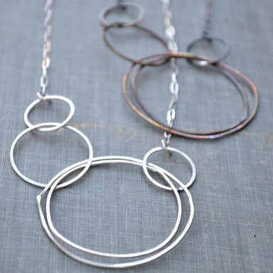 Multi Circle Necklace: A funky cluster of hand-forged sterling silver and antiqued brass circles, making you the life of the party—because who needs a plain necklace when you can have a statement piece that dangles and swings?
