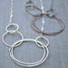 Multi Circle Necklace: A funky cluster of hand-forged sterling silver and antiqued brass circles, making you the life of the party—because who needs a plain necklace when you can have a statement piece that dangles and swings?