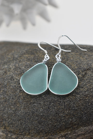 Close-up of Eco Glass Bezel Drop Silver Earrings, featuring organic bezel drop design that resembles sea glass, ideal for elegant and sustainable accessory choices.