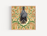 Framed art print of a bat hanging upside down against retro floral pattern background