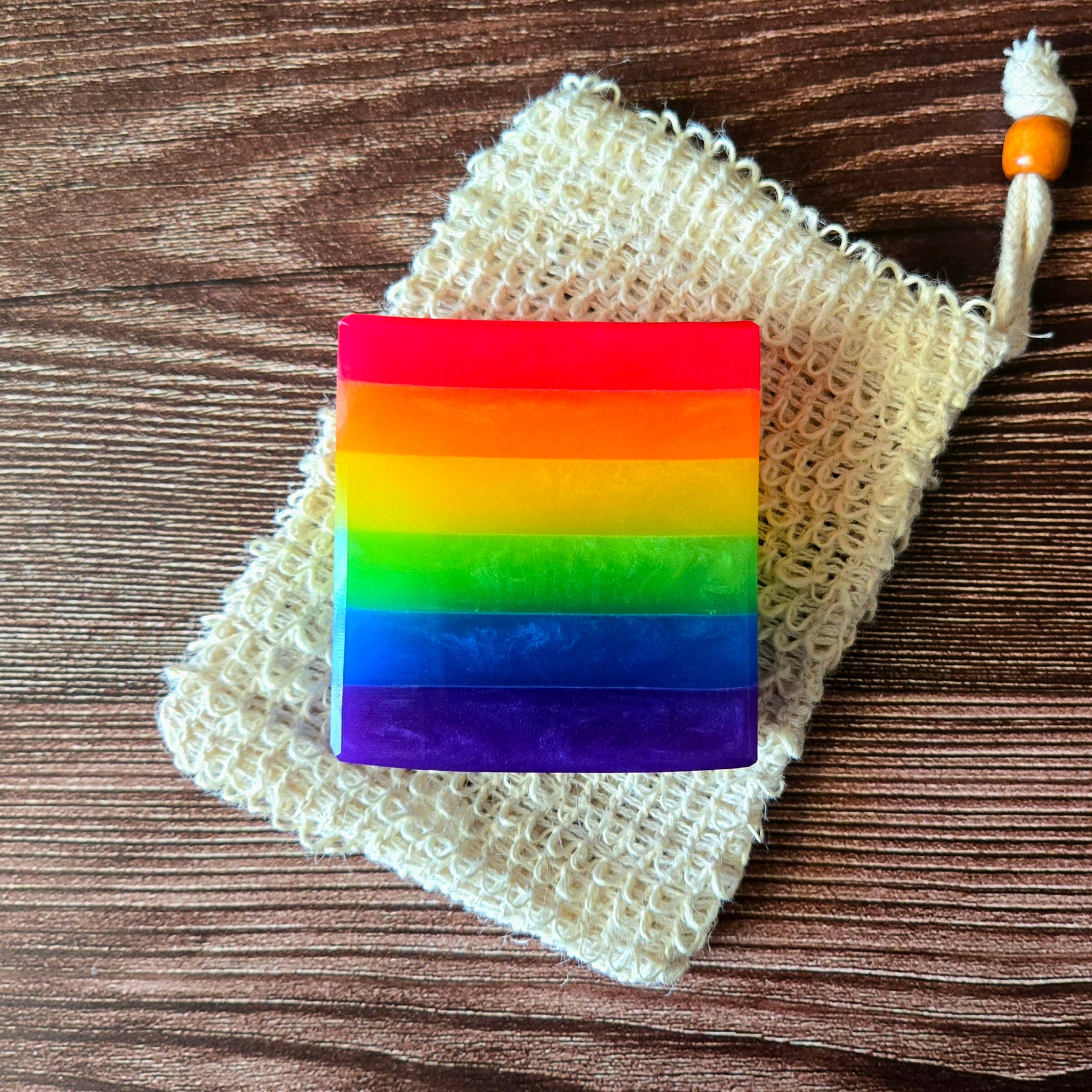Vegan ingredients used in Rainbow Pride Handcrafted Soap depicted among colorful design, promoting skin-friendly qualities.