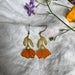 Begonia Stained Glass Resin Earrings showcasing a brass botanical design that dazzles like a rainbow in sunlight.