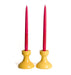 yellow candlestick holder with red candles