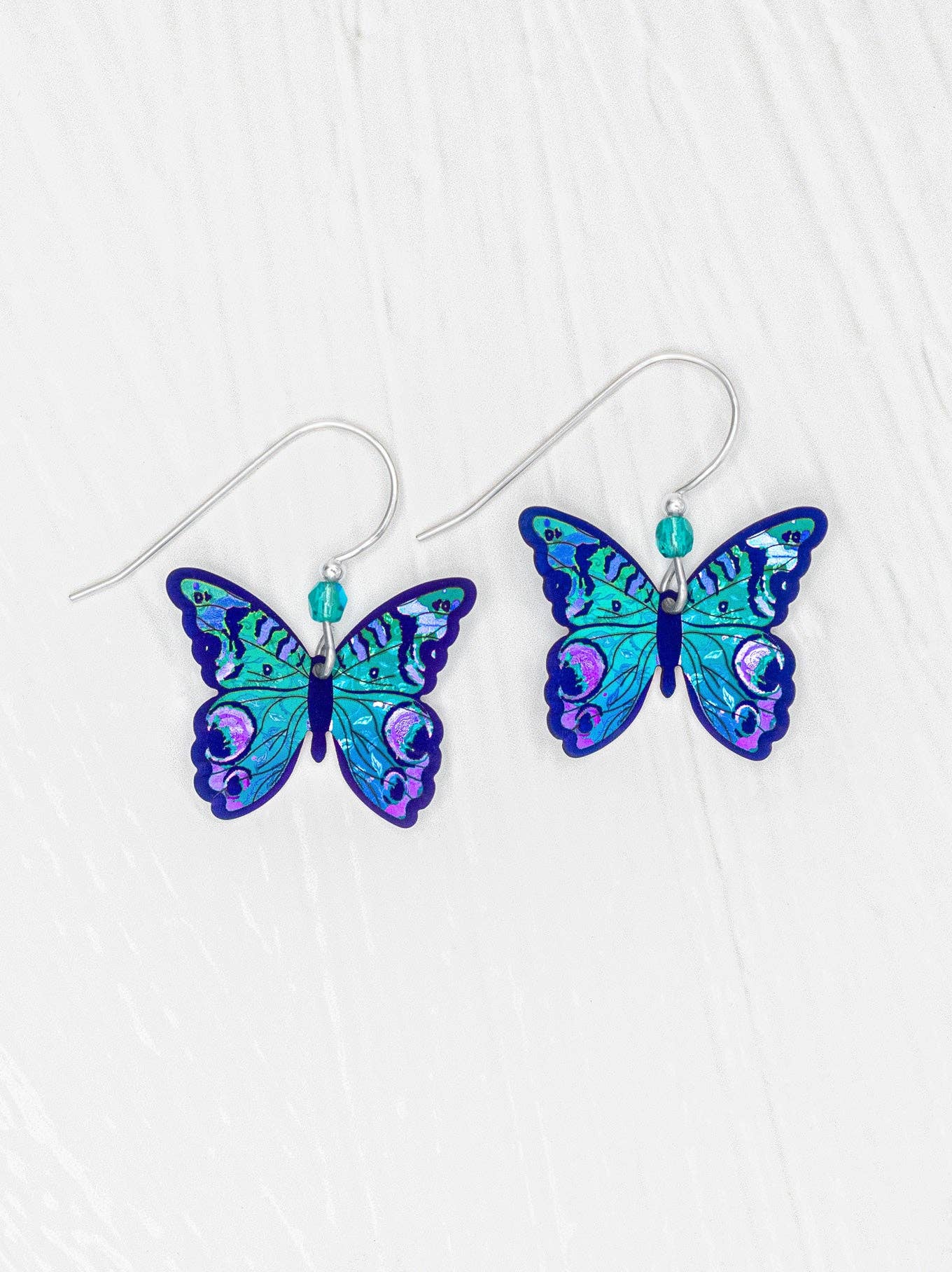 Mariposa Butterfly Earrings: Sterling silver ear wires and niobium combine to create a whimsical, lightweight accessory that daintily flutters from your earlobes like a fancy insect party on your head!