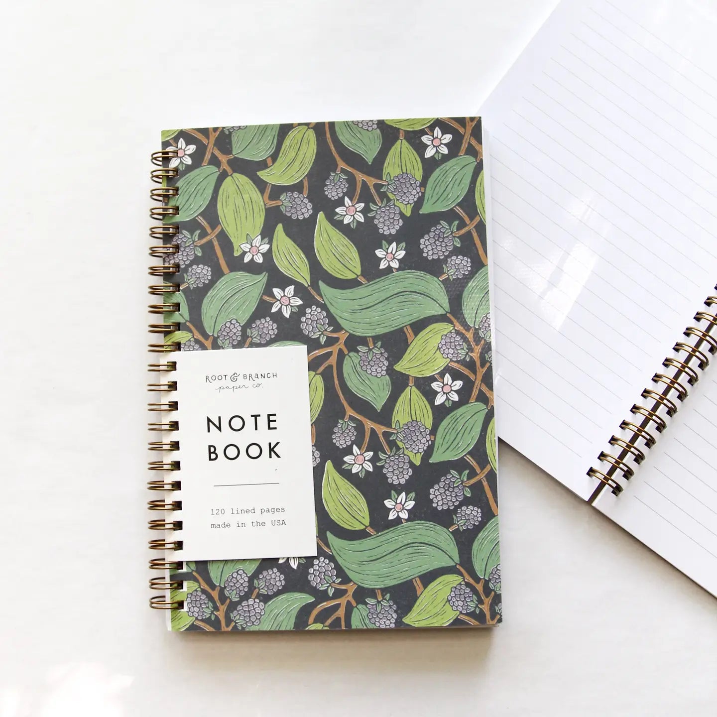 Root & Branch Spiral Bound Notebooks showcased with minimal plastic packaging, promoting sustainability and Earth-friendly practices.