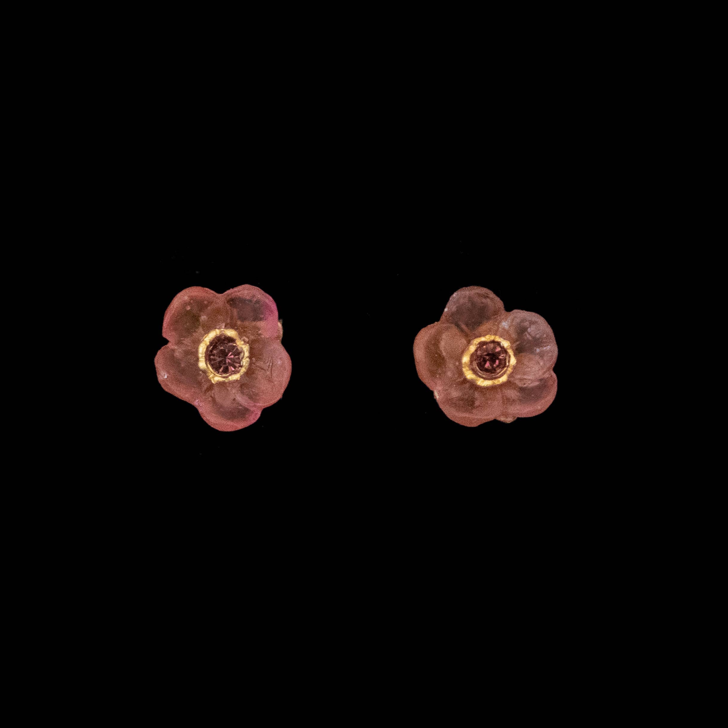 Close-up view of French Bouquet Stud Earrings by Michael Michaud, showcasing detailed cast bronze flowers with a hand patina finish, accented with glass and a crystal center in pink hues.