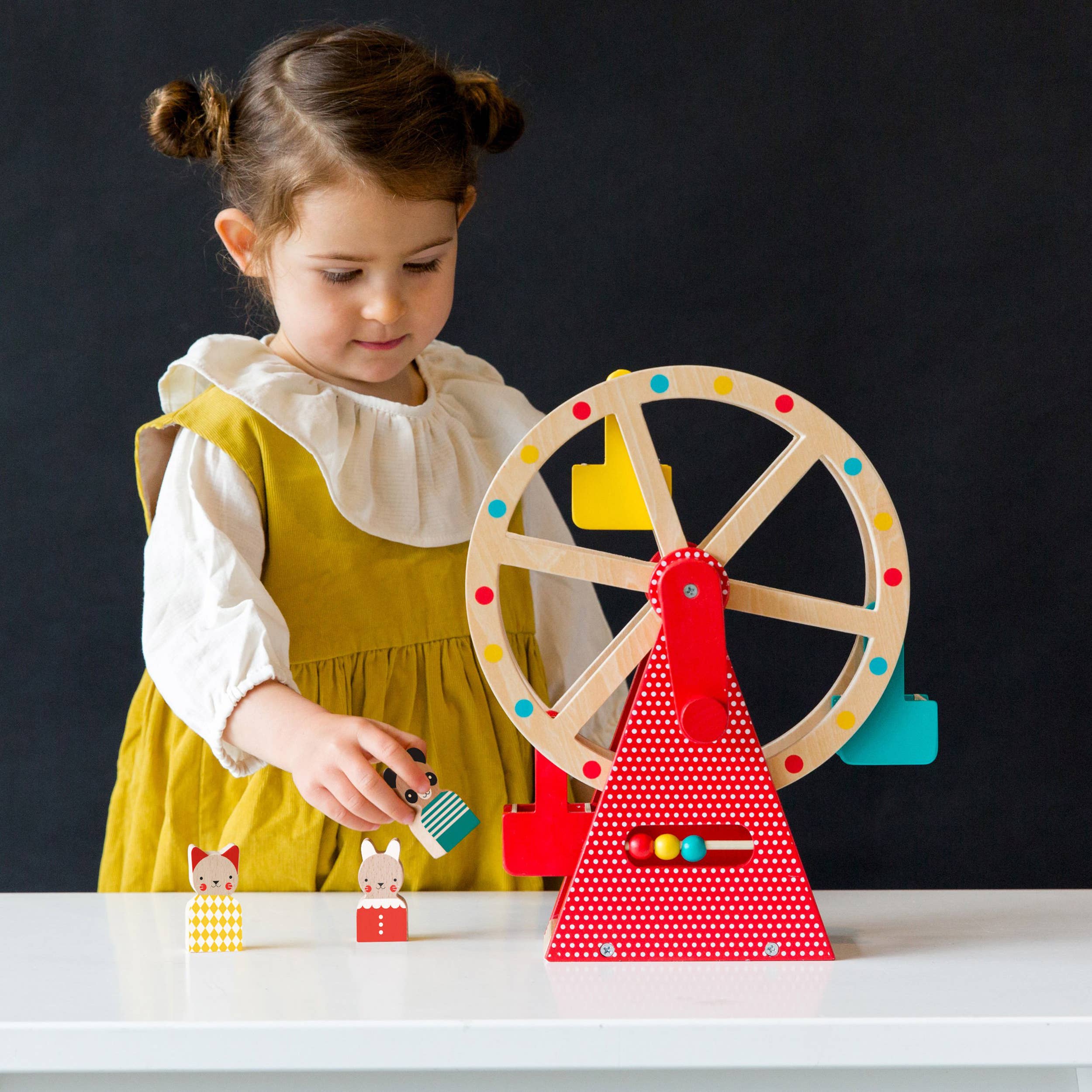 Little girl playing Wooden Ferris Wheel Carnival Play Set