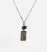 Flower Power Necklace by Suzanna Garrett Designs — a dainty wildflower pendant gets a little extra texture from dark river stone pebbles