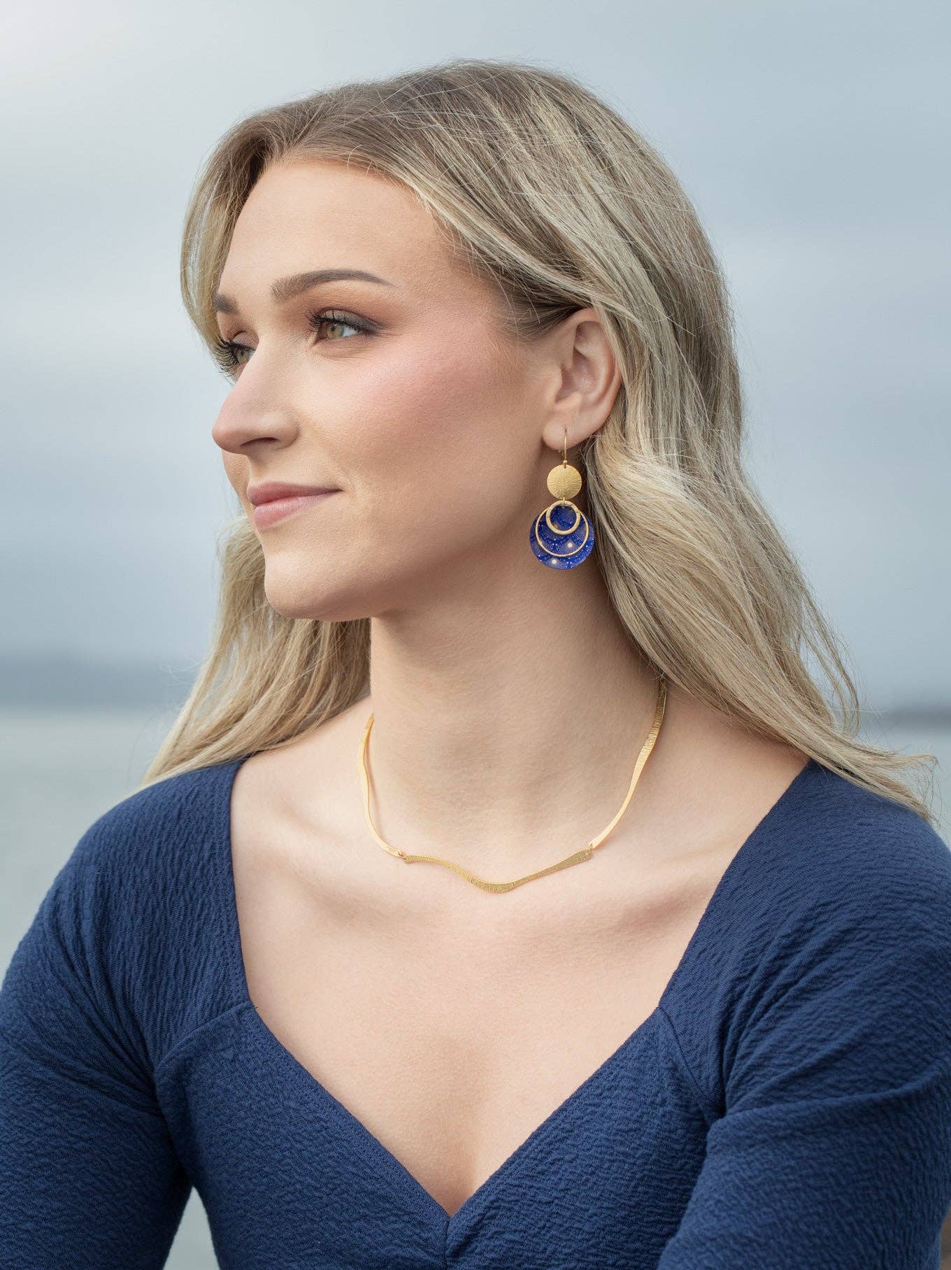 Atlas Earrings from Holly Yashi, featuring 18K gold-plated cosmic charm with a niobium sphere and intricately designed constellation artwork, perfect for stylish stargazing.