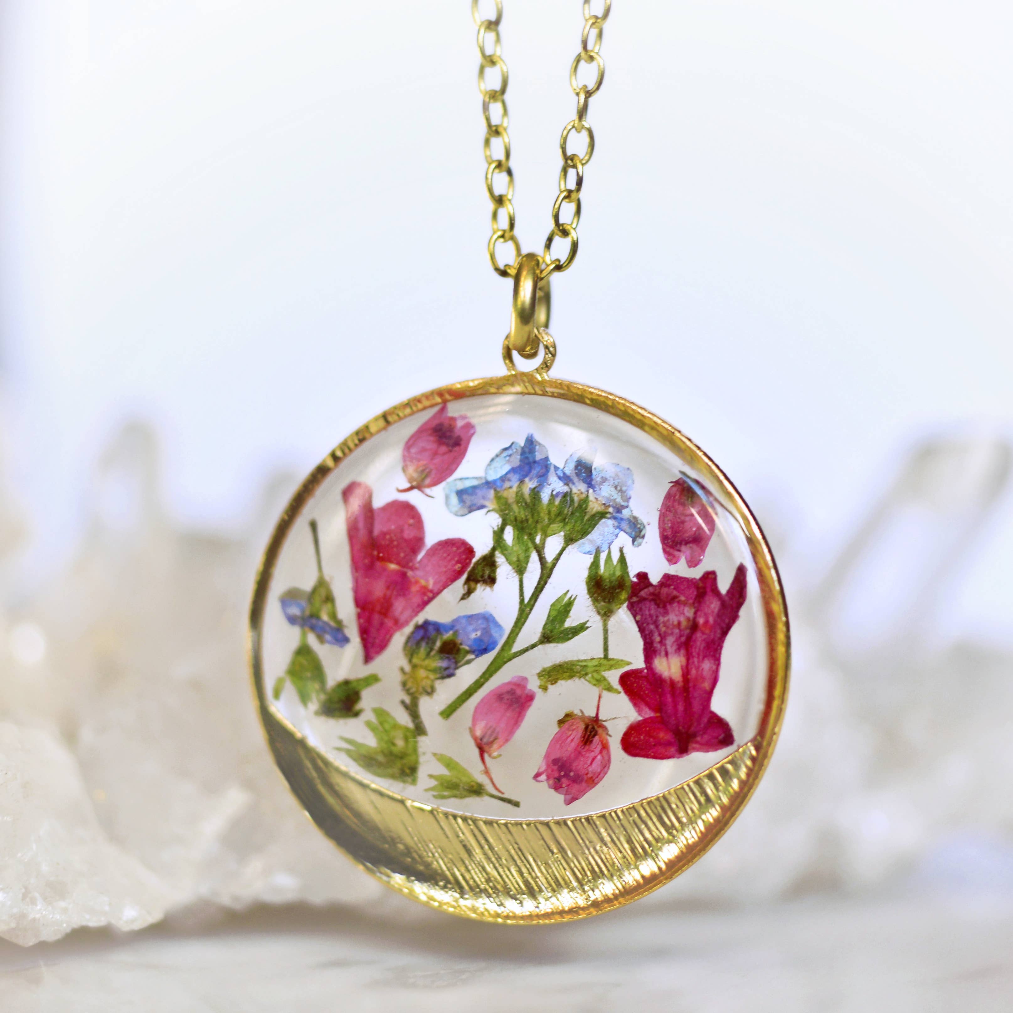 Garden Variety Flower Confetti Gold Moon Necklace displayed with floral design including coral bells and forget-me-nots.