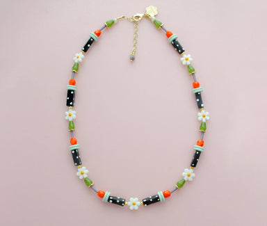 Chic black and white polka dot flower necklace by Jill Makes, perfect for adding a dash of whimsy to your outfit – your wardrobe will thank you for this colorful upgrade!