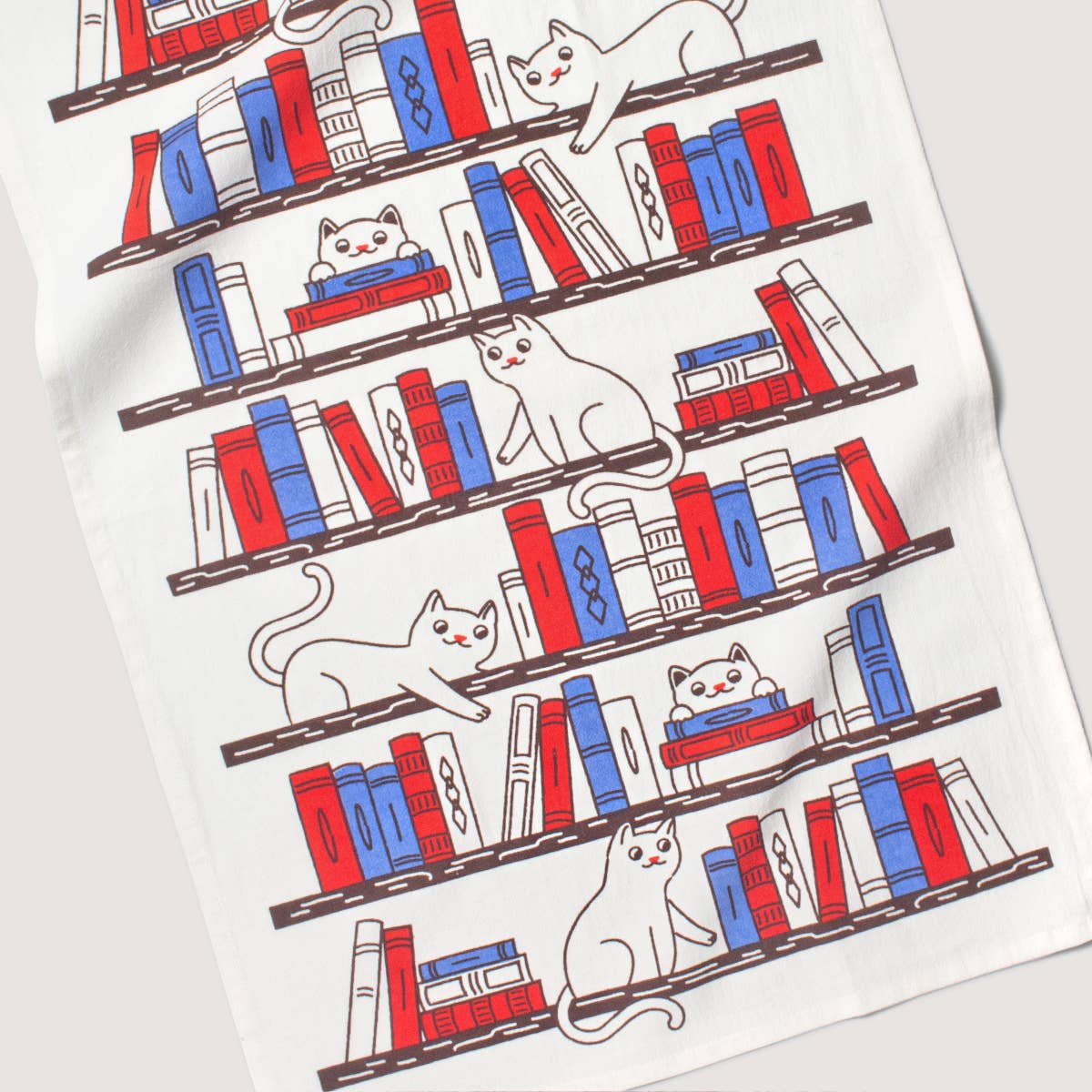 Cat on a bookshelf tea towel