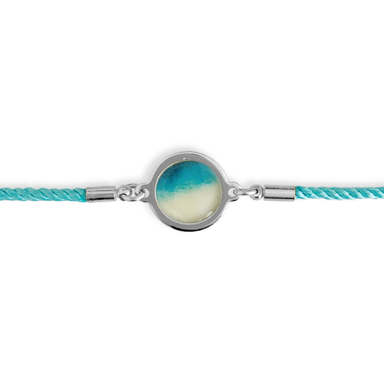 Slide Bracelet - Rise With The Tide: Silver / Turquoise by Foterra Jewelry showcasing a stylish nylon cord with a circular silver bead design.