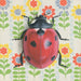 Ladybug White - Fine Art Print - Insect Illustration by Emily Uchytil, showcasing a detailed red ladybug against a whimsical flower backdrop.