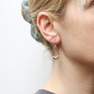 Close-up of Small Teardrop with Accent Rings Wire Earrings showcasing unique design with brass and silver tones, perfect for adding a fun touch to any outfit.