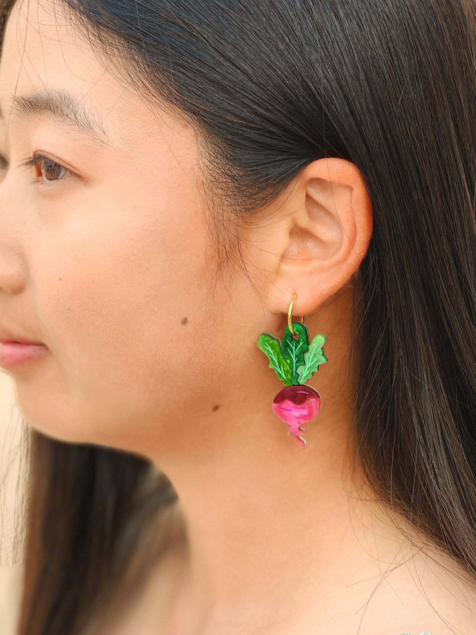 Model wearing Ruby Radish Dangle earrings by Sunnie Creative, displaying the quirky design of radish earrings, suitable for casual wear.