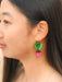 Model wearing Ruby Radish Dangle earrings by Sunnie Creative, displaying the quirky design of radish earrings, suitable for casual wear.