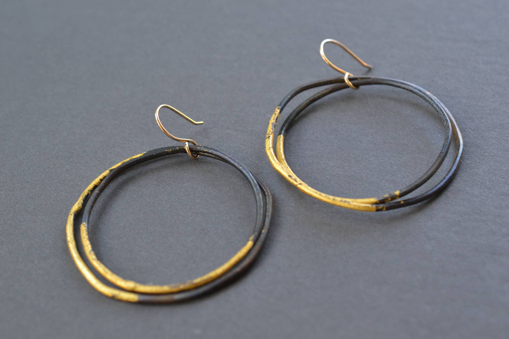 Close-up of the Steel and Gold Heavy Gauge Hoops, because who wouldn't want to wear a piece of art that sparkles more than a disco ball?