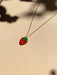 Mini Strawberry Necklace by Sunnie Creative, featuring a vibrant strawberry pendant on a delicate chain against a soft background.