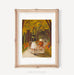 The Hollow Art Print by Janet Hill Studio depicting a whimsical scene of a girl riding a bicycle with a pumpkin and flowers along a tree-lined path, perfect for adding charm to any decor.