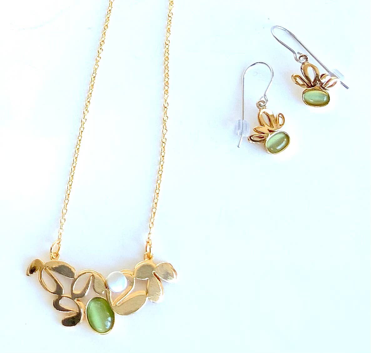 gold jewelry with green gemstones