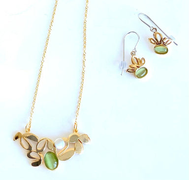 gold jewelry with green gemstones