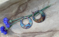 Display of Boho Large circle earrings on a card, highlighting their intricate copper detailing and protective coating.