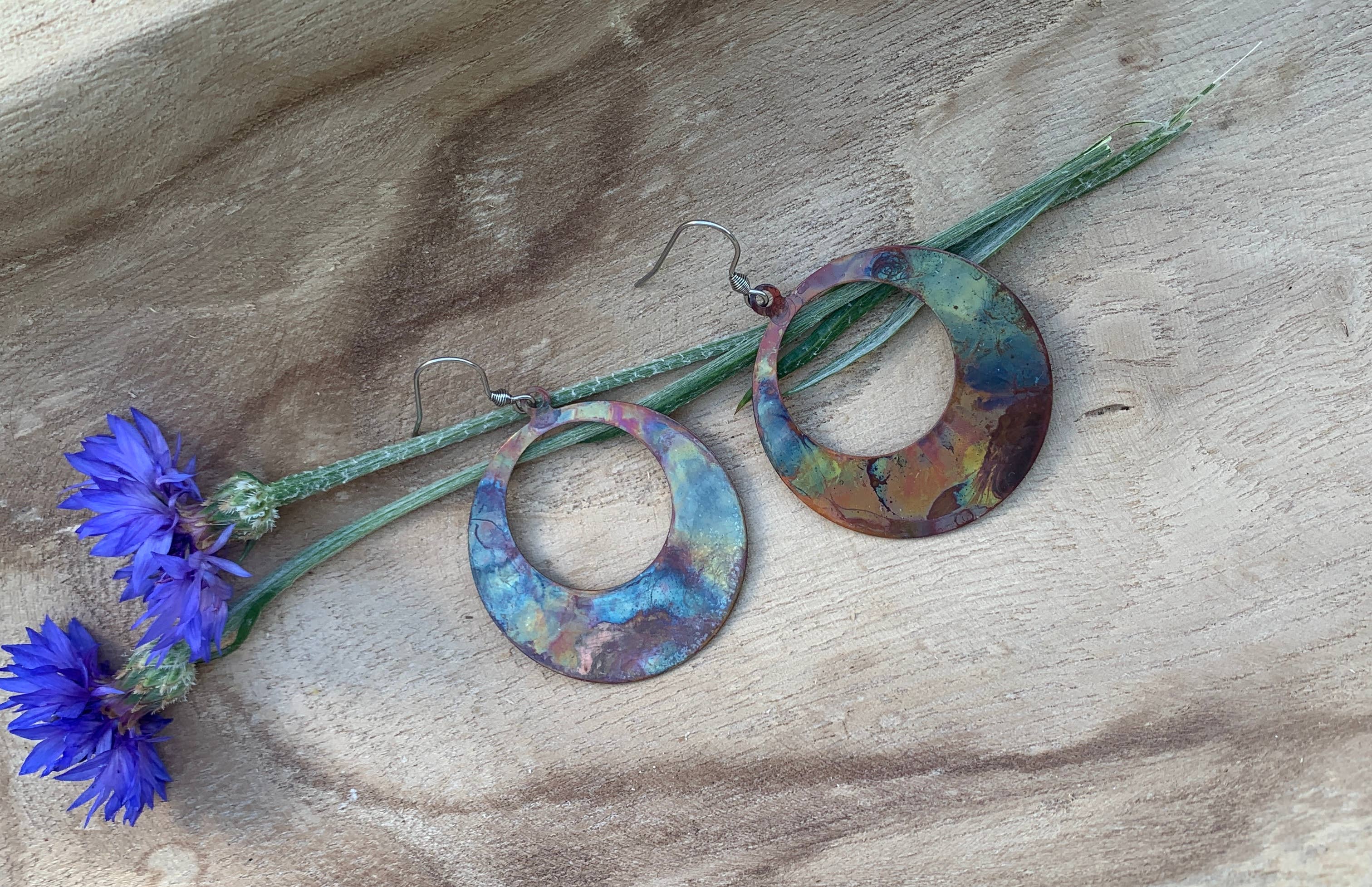 Display of Boho Large circle earrings on a card, highlighting their intricate copper detailing and protective coating.