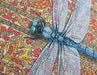 Framed art print of a dragonfly over a patterned floral background.