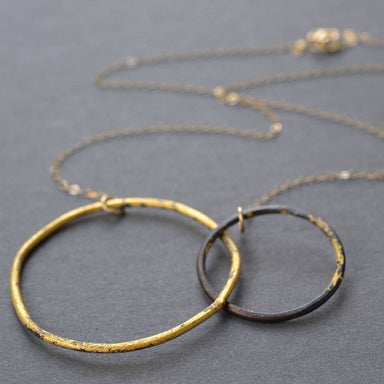 Interlocking Circles Necklace Steel & Gold: A bold statement piece that fuses heavy-duty steel with glamorous 23k gold, perfect for adding a sparkle to your outfit and sparking conversations about the beauty of mixed metals!