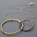 Interlocking Circles Necklace Steel & Gold: A bold statement piece that fuses heavy-duty steel with glamorous 23k gold, perfect for adding a sparkle to your outfit and sparking conversations about the beauty of mixed metals!