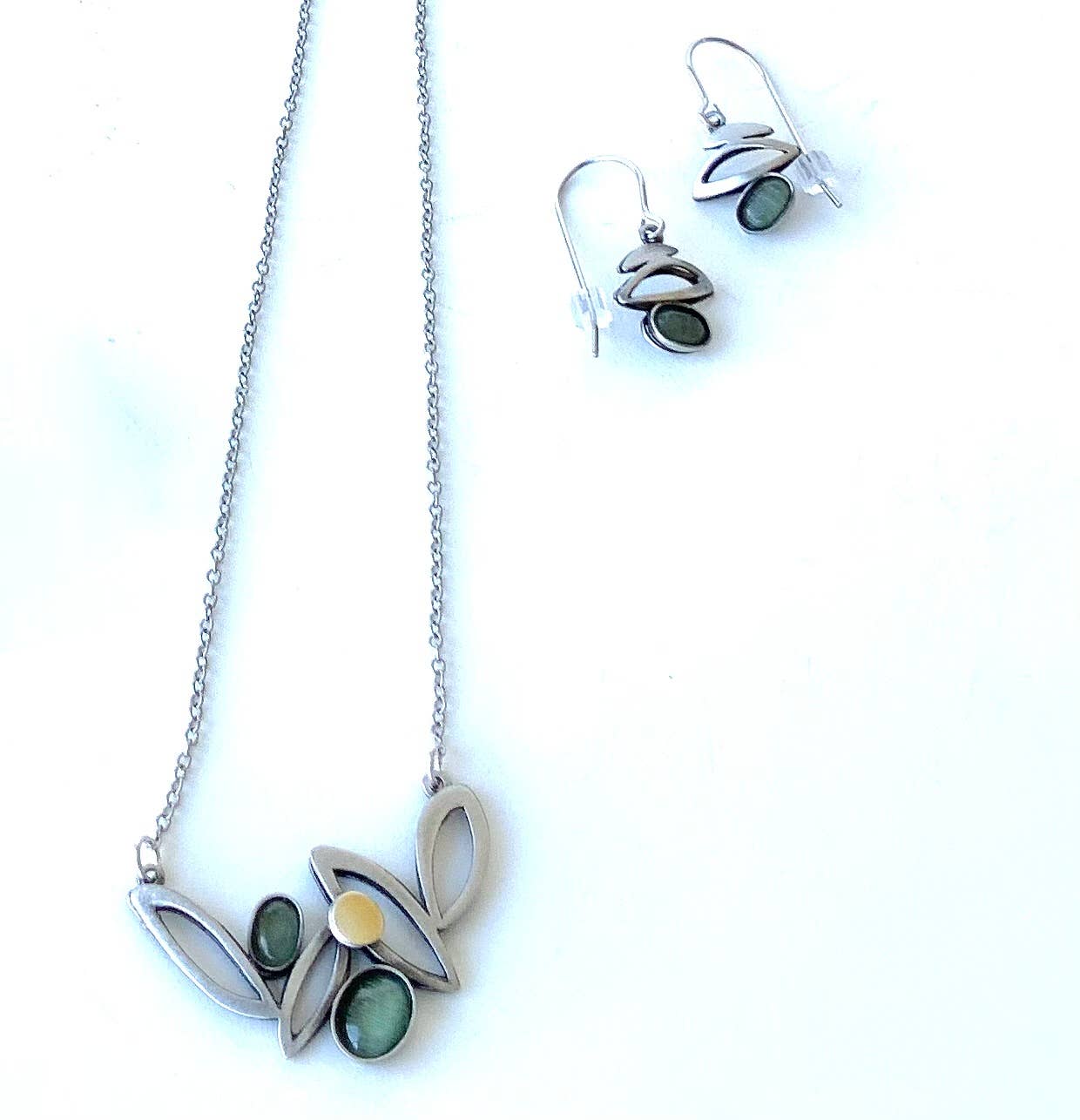 steel jewelry with green gemstones