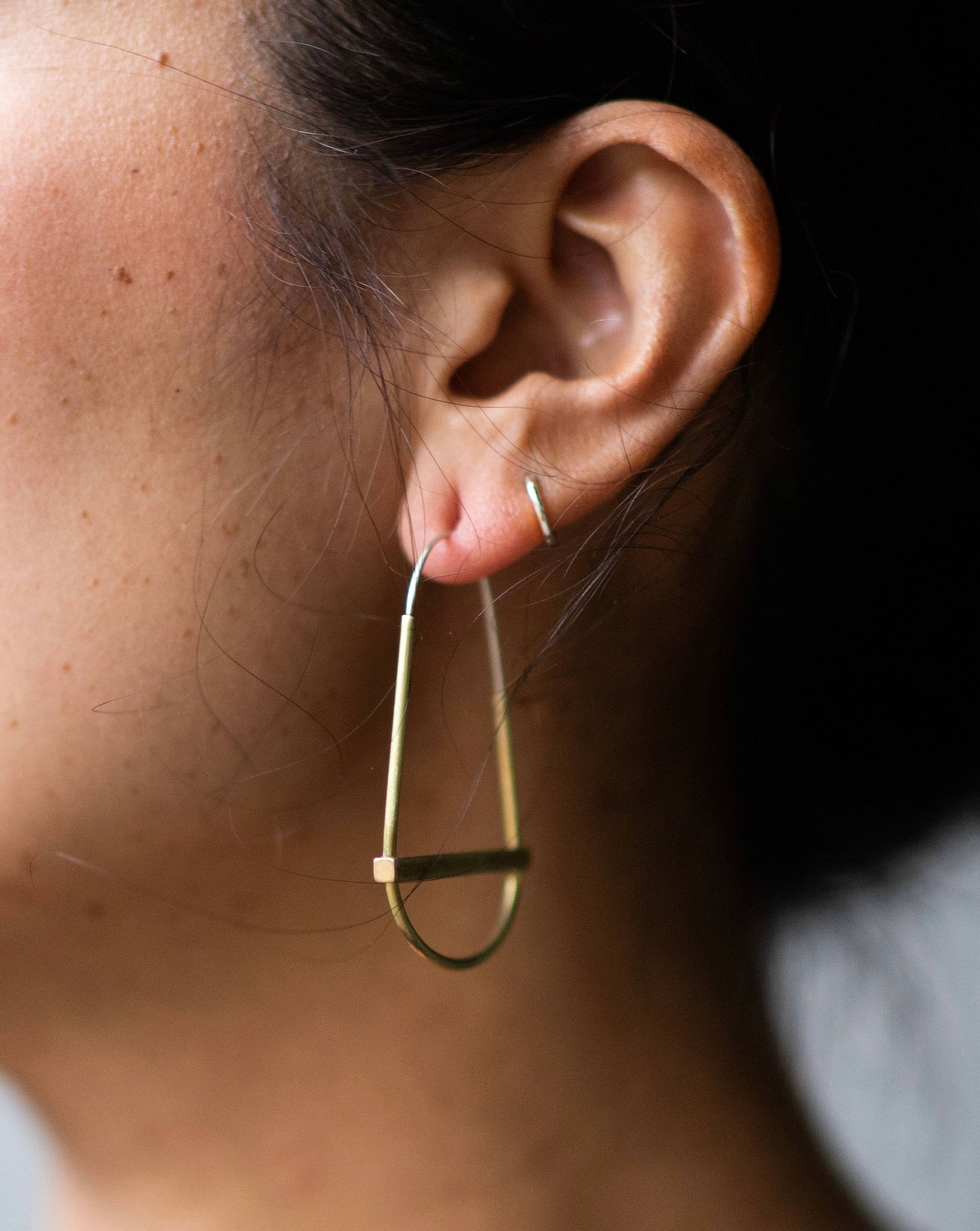 gold hollow hoop with crossbar earrings