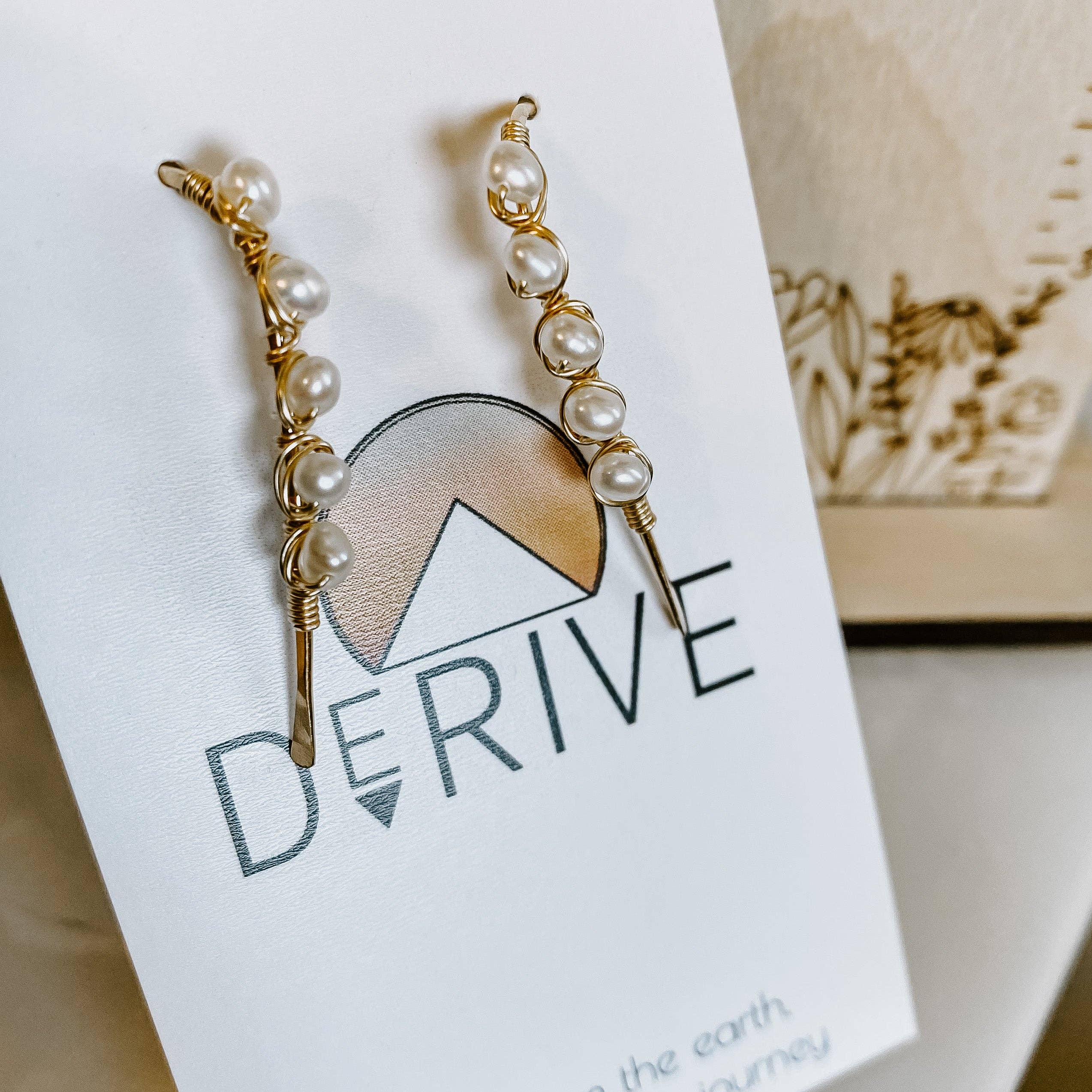 The chic packaging of the Mini Pearl U Shaped Threader Earrings, enticing you to unwrap luxury like a kid on Christmas morning.