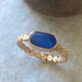The Repetition Band by Kate Samson Design, featuring a distinctive sea glass ring in a rich blue color, set in a 14k gold fill bezel with a handmade beaded band.