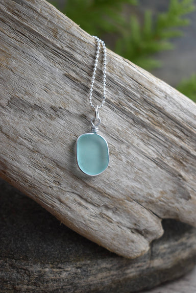 Solo Wired small Glass pendant in Periwinkle Blue by Whitelotus Design, showcasing eco-friendly ocean-inspired jewelry with a unique frosted surface and sterling silver chain.