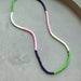 Lithe No. 2 Beaded Necklace by The Silver Wren featuring vibrant multicolor seed beads in green, pink, white, and deep navy, perfect for adding a playful pop of color to any outfit.