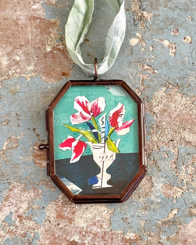 Vintage-style flower art locket ornament.