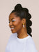 A woman wearing Split Dip Earrings by Twenty Two West, smiling against a neutral background, showcasing the earrings' vibrant colors and elegant design.